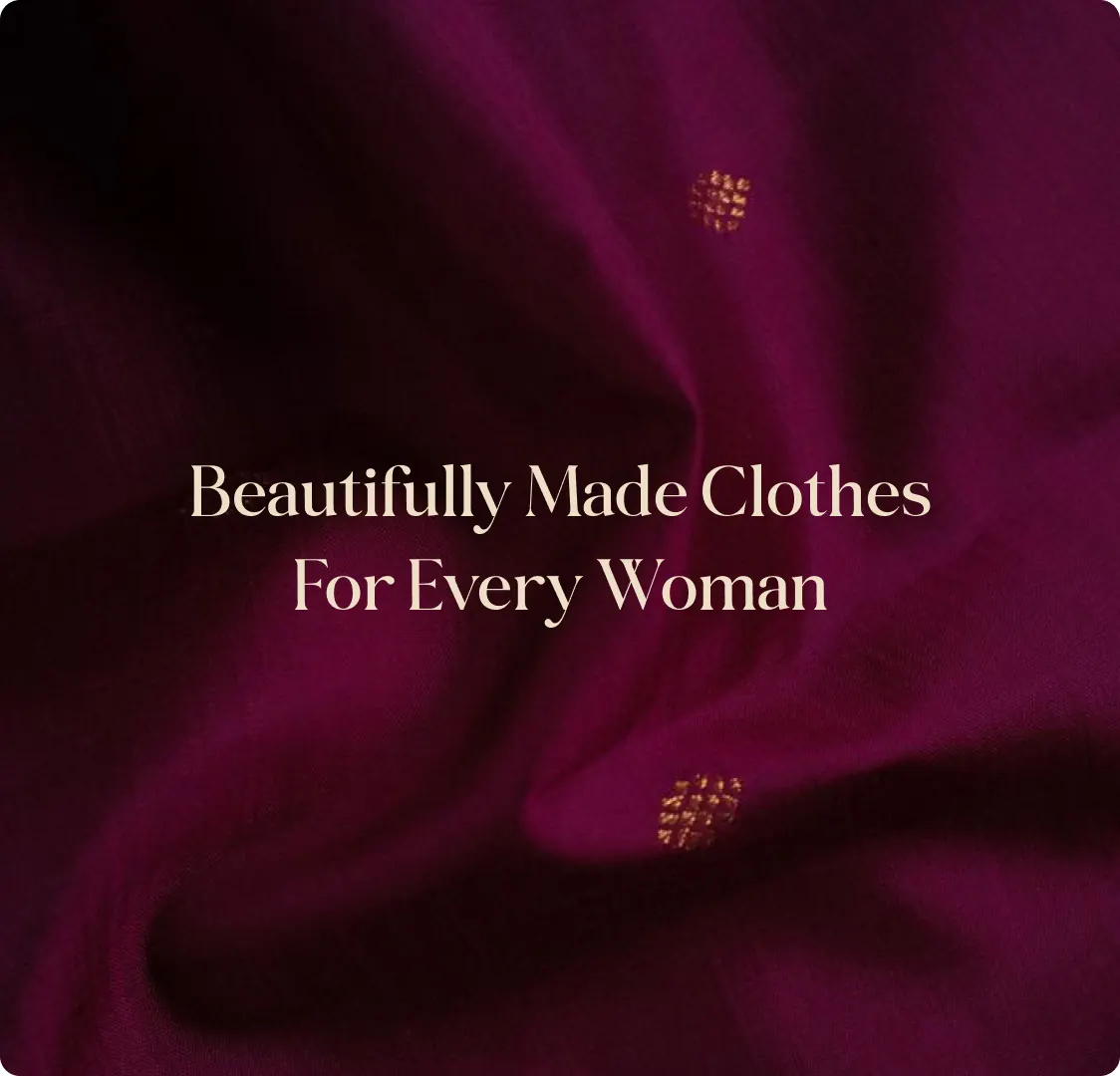 A close-up of magenta silk with small gold motifs, carrying the line Beautifully Made Clothes For Every Woman.