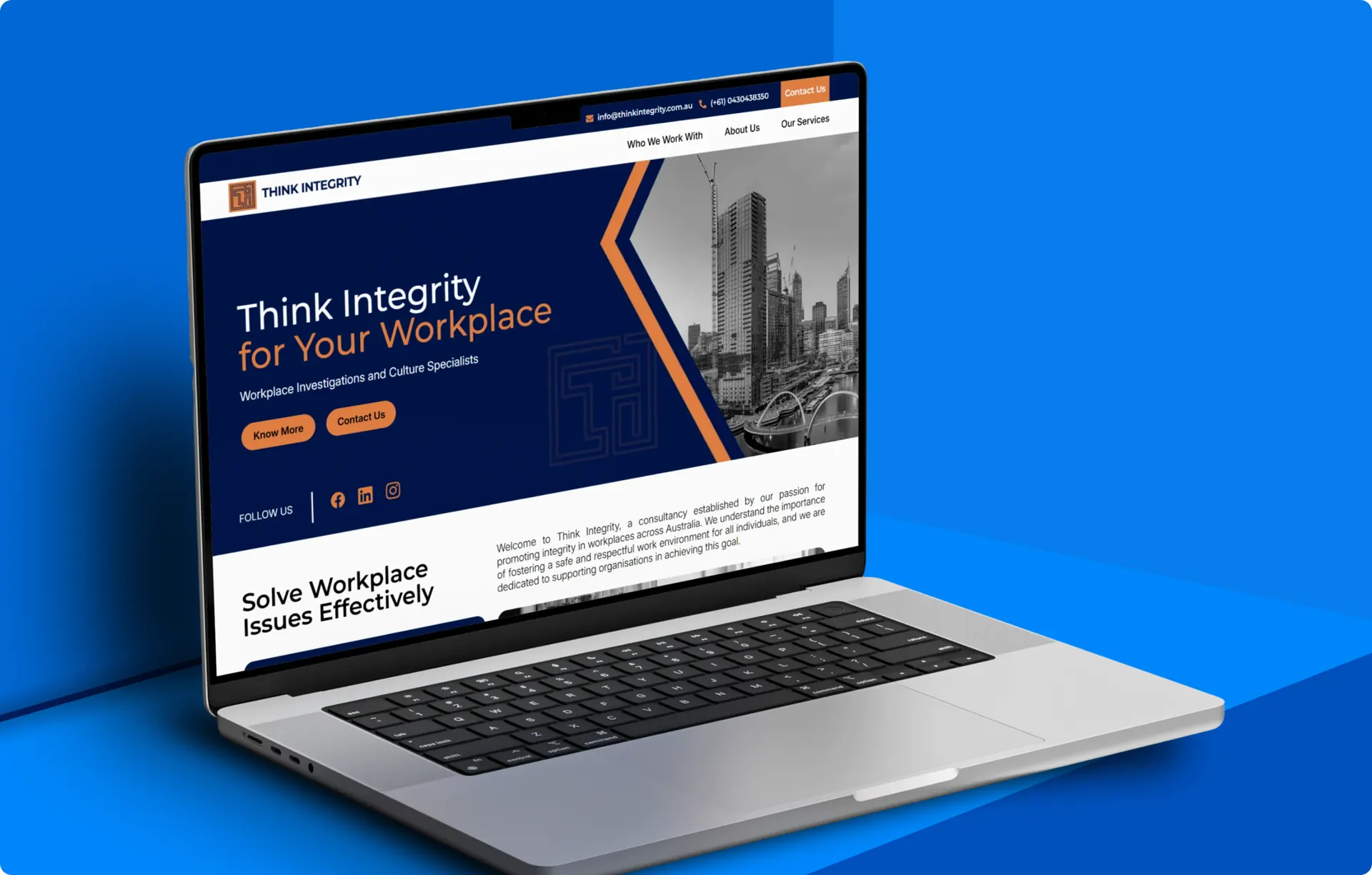 A laptop showing the Think Integrity homepage, with a navy hero, the headline Think Integrity for Your Workplace and a black and white city skyline to the right of it.