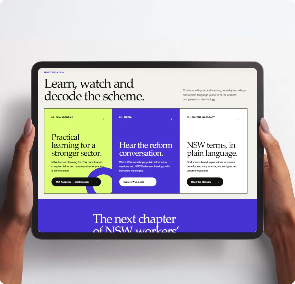 A tablet held in two hands showing the learning section, with three coloured panels for the academy, media and the scheme glossary.